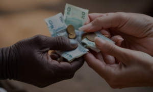 hands exchanging money in a microfinance transaction